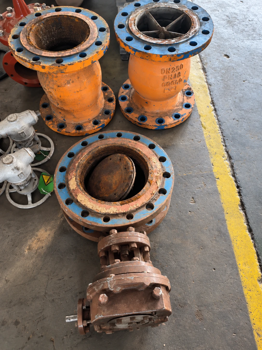 Worn flanged valves on the workshop floor